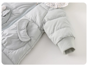 Detailed view of baby winter romper with floral ruffle collar and ribbed cuffs for warmth