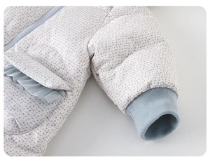 Detailed view of floral baby romper with blue ruffled edges and ribbed windproof cuffs