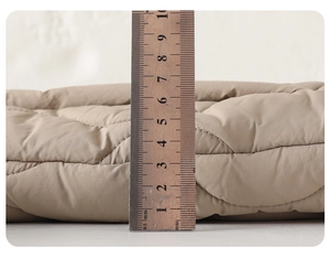 Close-up of baby winter jumpsuit showing quilted texture and 7cm thermal thickness