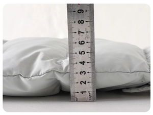 Close-up of quilted gray baby jumpsuit showing the 3.5cm thick insulation and soft fabric