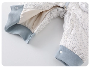 Detail of floral baby romper showing zipper, snaps and soft warm lining texture