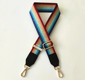 Close-up of rainbow glitter woven shoulder strap with gold metal hooks and black leather