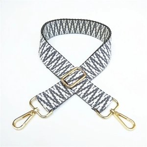 Detail of adjustable woven bag strap featuring black and white geometric wave patterns