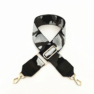 Detail of adjustable camo shoulder strap with premium gold metal buckles for handbags