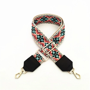 Macro detail of bohemian woven bag strap with geometric patterns and gold metal clasps