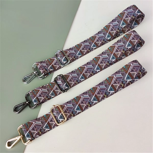 Detail view of woven bohemian guitar straps with silver, gunmetal, and gold metal hardware