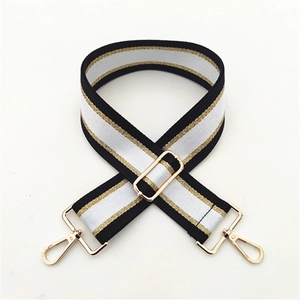 Detail of adjustable thickened striped shoulder strap with gold metal hooks for handbags