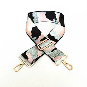 Detail of wide camo woven strap with gold metal lobster clasps and adjustable buckle