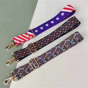 Close-up of three ethnic pattern adjustable wide shoulder straps with gold metal hooks
