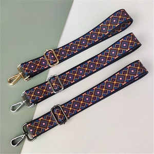 Close-up of geometric woven straps with adjustable gold, silver and gun black buckles