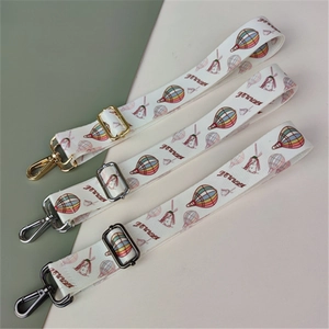 Close-up of three replacement wide straps with hot air balloon prints and metal buckles