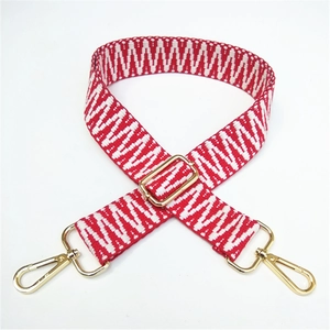 Adjustable woven replacement bag strap with red and white geometric patterns and gold clips