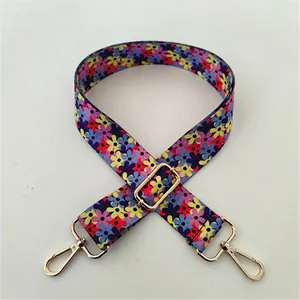 Close-up of wide floral replacement strap with gold lobster clasps and buckles