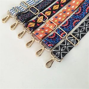 Close-up of adjustable colorful ethnic pattern bag straps with gold metal clasps
