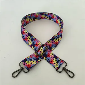 Close-up of ethnic floral woven wide shoulder strap with dark gunmetal swivel hooks