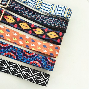 Close-up of colorful ethnic woven bag straps with adjustable gold-tone metal buckles