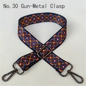 Close-up of ethnic geometric pattern webbing strap with gunmetal swivel hooks and buckle