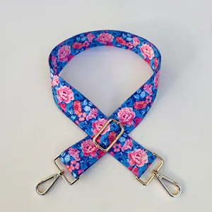 Close-up of floral bag strap #39 with pink roses and gold-tone metal hardware clips