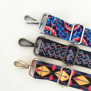 Detailed close-up of three ethnic pattern bag straps with premium metal swivel hooks