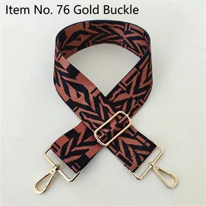 Close-up of ethnic geometric woven strap with golden hooks and adjustable slider
