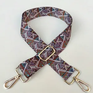 Detail of bohemian geometric patterned strap with gold metal lobster clasps and buckle