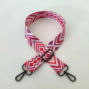 Close-up of No. 96 gunmetal hook and red-purple geometric patterned wide bag strap