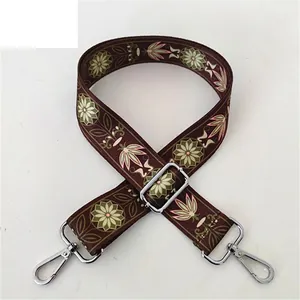 Detail of vintage floral replacement bag strap with pink and green patterns and silver hooks