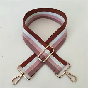 Close-up of colorful striped woven replacement strap with adjustable gold metal buckle