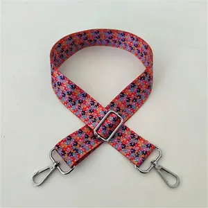 Close-up of floral canvas bag strap with silver metal buckles and No. 92 pattern