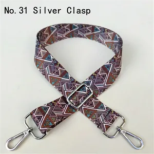 Close-up of ethnic geometric pattern strap with silver adjustable metal buckle and hooks