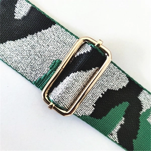 Detail of camouflaged woven strap featuring adjustable gold metal buckle and texture