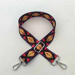 Close-up of ethnic geometric woven bag strap with silver metal buckle and lobster clasp