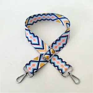 Close-up of geometric pattern replacement bag strap with silver metal swivel hooks