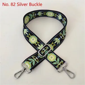 Close-up of ethnic style embroidered bag strap with floral pattern and silver buckle