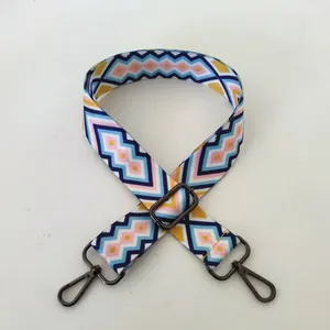 Detail view of ethnic geometric weave shoulder strap with gunmetal swivel clasps