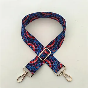 Close-up of Style 57 adjustable ethnic crossbody strap with colorful patterns and gold buckles