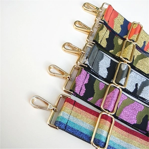 Detail of wide camo and rainbow replacement straps with golden metal lobster clasps