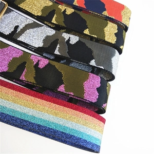 Detailed macro view showing diverse colorful ethnic patterns and metallic buckle on wide bag straps