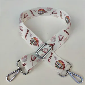 Detail of colorful floral strap with hot air balloon patterns and silver metal buckles