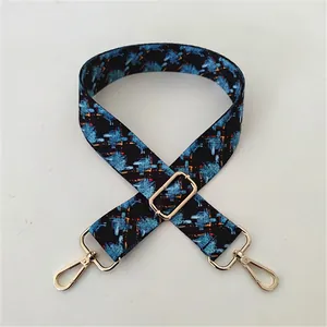 Close-up of No. 94 ethnic style woven strap with floral patterns and gold metal buckles