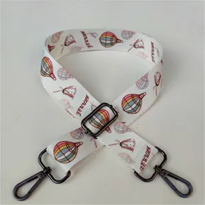 Detail of adjustable off-white strap featuring colorful hot air balloon and windmill prints