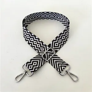 Detail of adjustable black and white geometric pattern strap with silver buckle No. 98