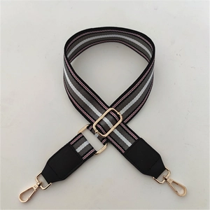 Adjustable wide striped shoulder strap with gold metal hooks and black leather reinforced ends