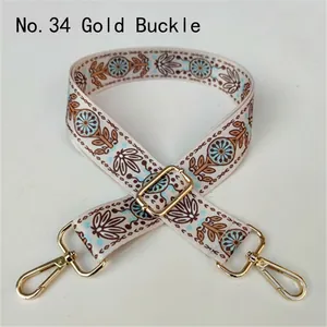 Close-up of ethnic style fabric shoulder strap with floral patterns and gold buckles
