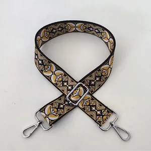 Detail of colorful ethnic pattern bag strap with silver metal buckle and adjustable clasp