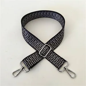 Adjustable black and white wavy pattern woven shoulder strap with silver metal hooks
