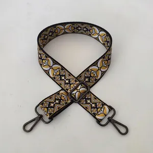 Close-up of geometric jacquard shoulder strap with gunmetal buckle for handbags