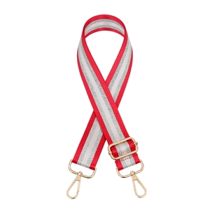 Close-up of red and silver striped adjustable nylon shoulder strap with gold metal hooks