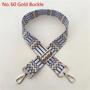 Close-up of geometric wave pattern woven strap with gold buckle and adjustable slider