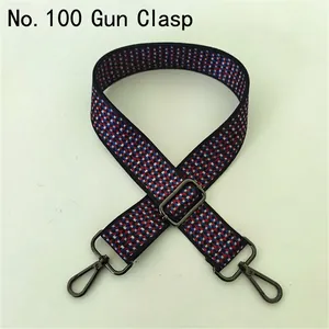 Close-up of ethnic woven bag strap with red and blue patterns and gunmetal metal buckles